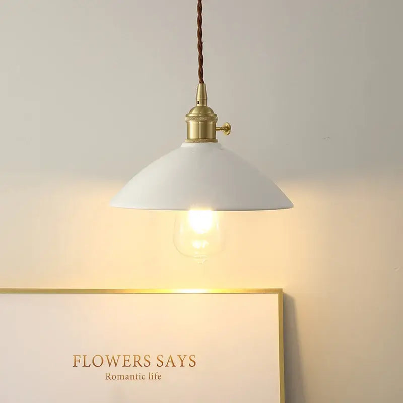 White enamel pendant light with brass fixture and decorbites ceramic knob switch featuring twisted brown cord