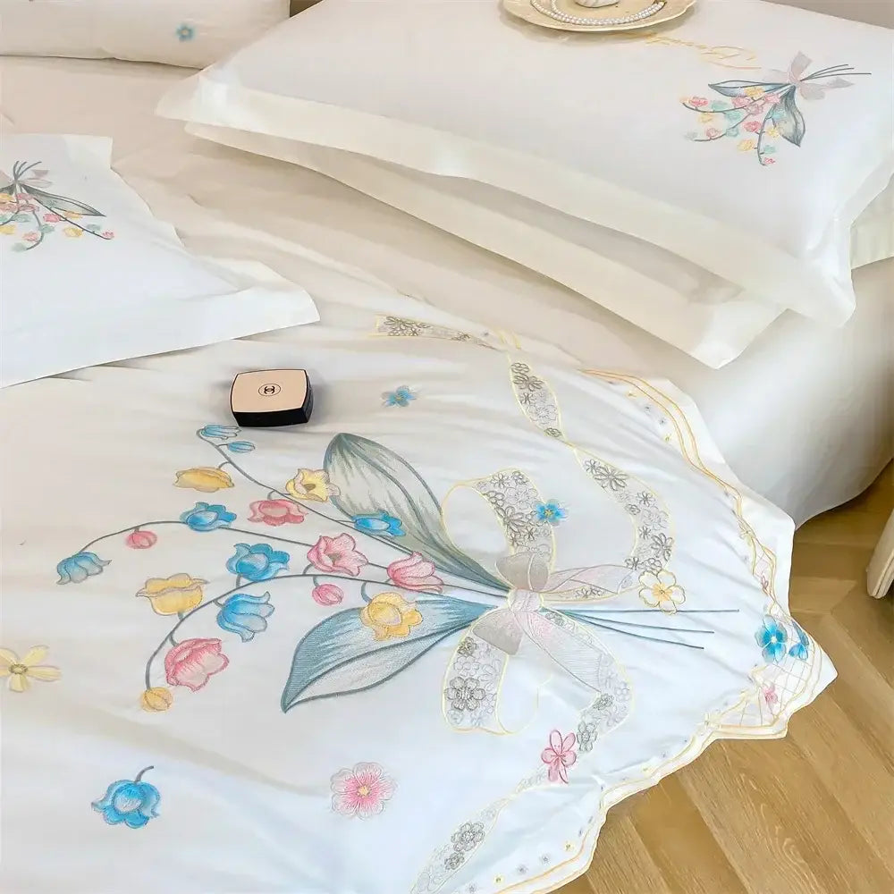 White satin bedding set with decorbites butterfly flowers embroidery and delicate pastel floral designs with central bow