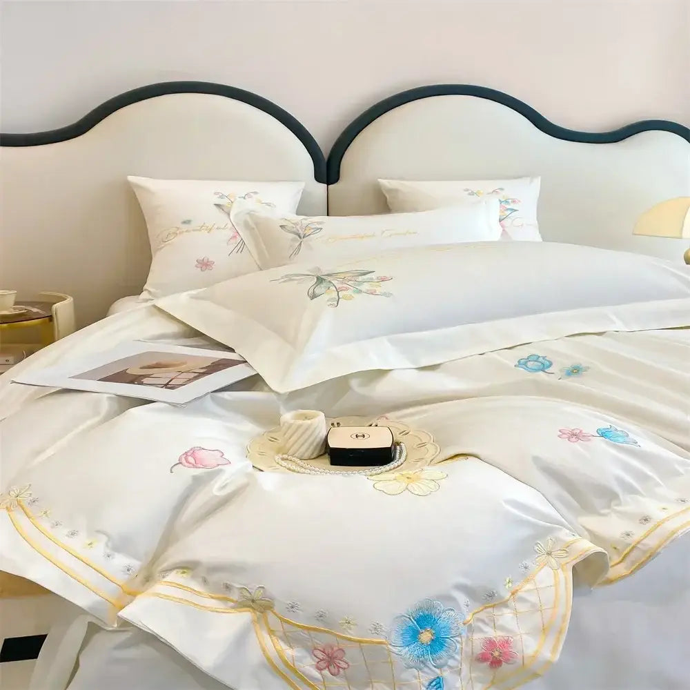 White satin bedding set with pastel pink blue and yellow decorbites butterfly flowers embroidery on edges and pillows