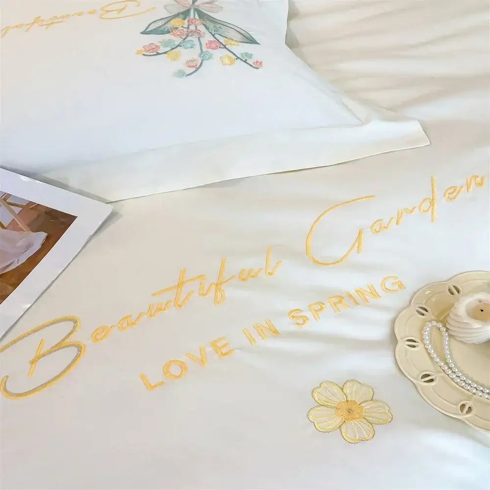 White satin bedding set with gold butterfly flowers embroidery and beautiful garden love in spring design from decorbites