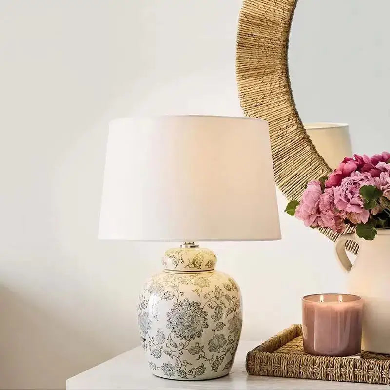 Cream-colored ceramic desk lamp with intricate black floral patterns and white fabric shade for bedroom decorbites decor