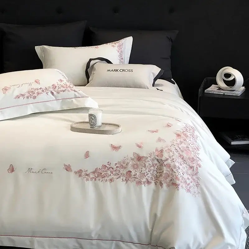 White floral Egyptian cotton bedding sets with delicate pink butterfly embroidery and subtle red piping in bedroom linens