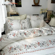 White floral embroidered cotton duvet cover set featuring delicate embroidery and soft flowing fabric for bedroom use