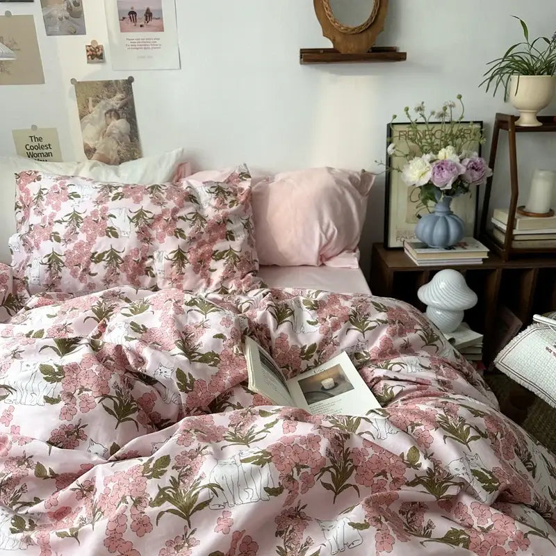Pink floral duvet cover set with delicate blossoms and green leaves on white embroidered cotton fabric for bedroom bedding