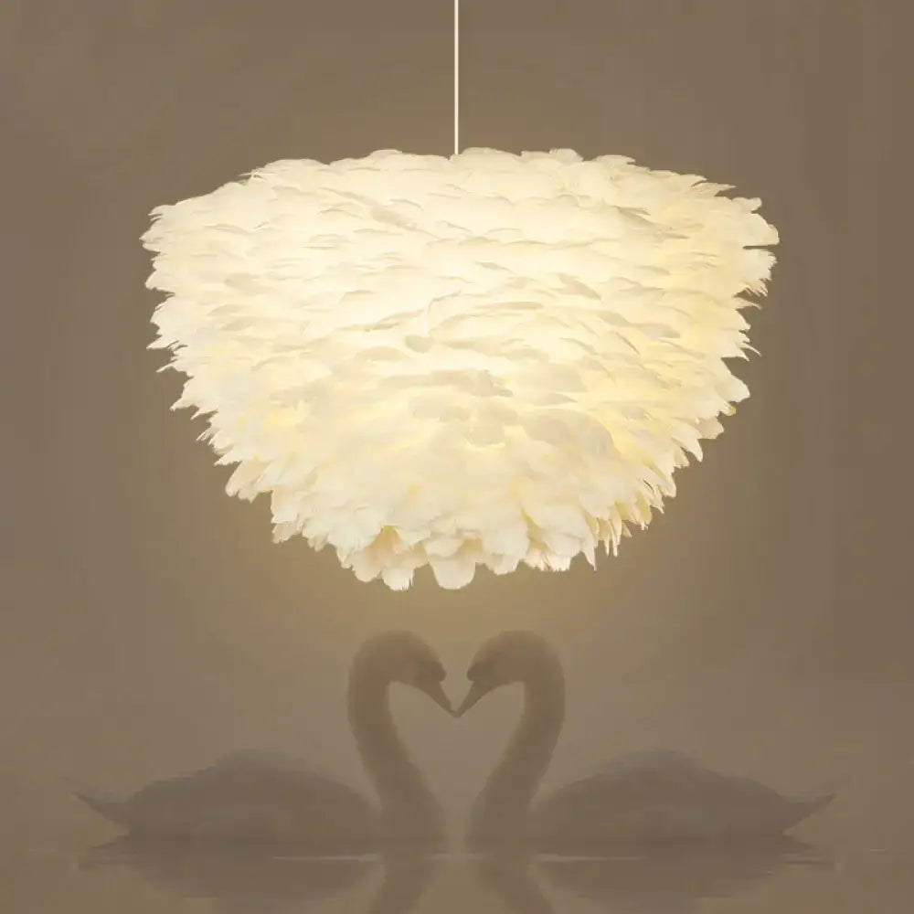 White floral pendant chandelier with off-white feather accents and a fluffy layered design for dining room use