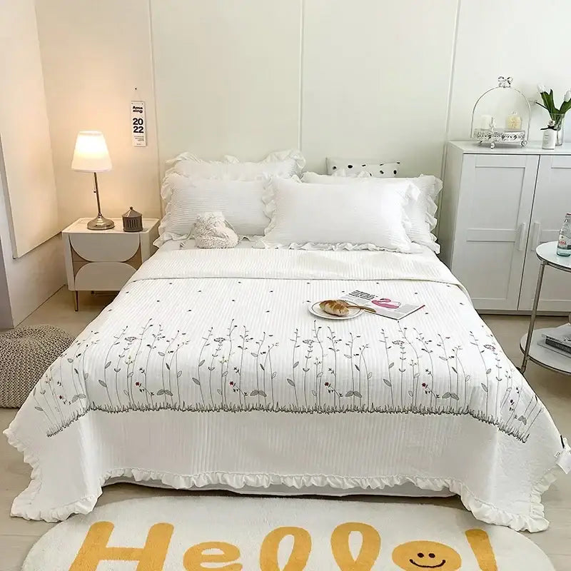 White quilt set with fresh flower embroidered gray floral details and ruffled edges in soft cotton bedding decorbites