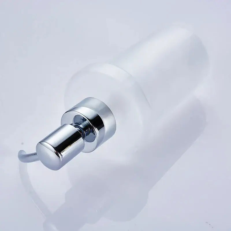 White frosted glass liquid soap dispenser with chrome finish and gold pump for bathroom use