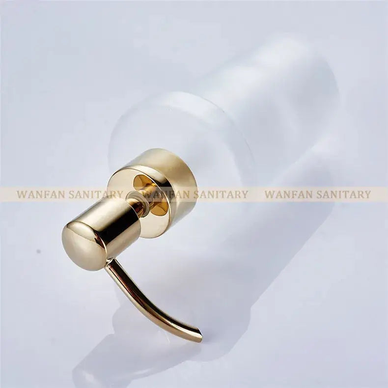 White frosted glass liquid soap dispenser with gold-toned metal pump for bathroom use
