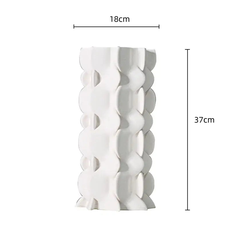 A tall white ceramic vase with a distinctive geometric ceramic fold pattern for living room decorbites decor