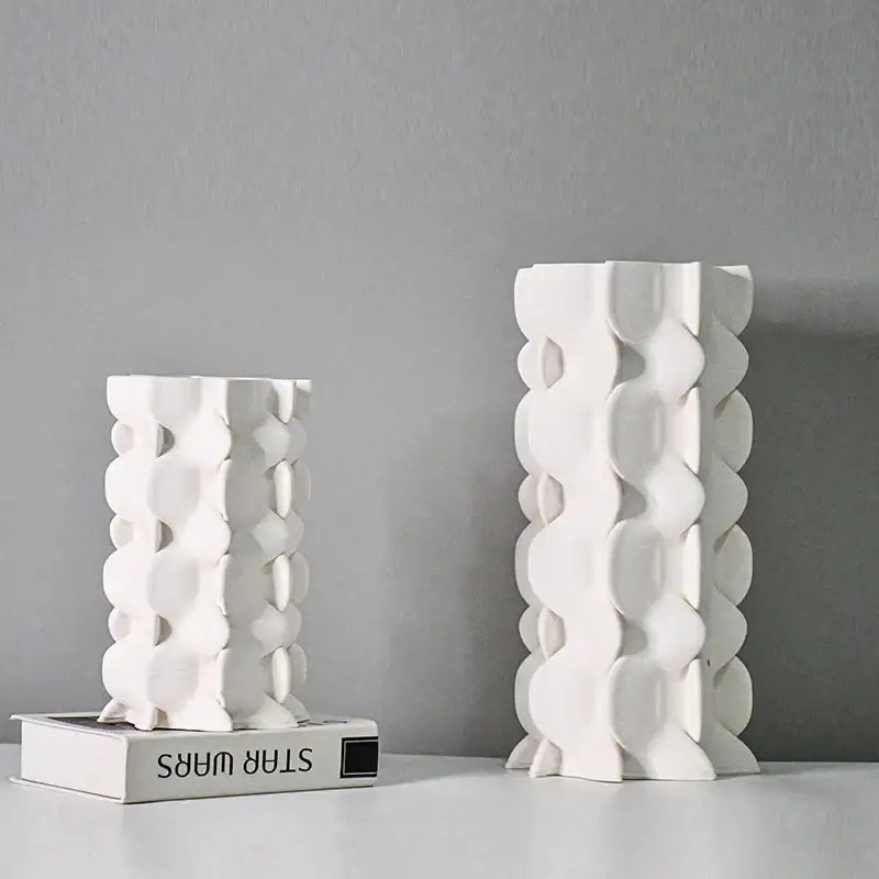 Two white geometric ceramic fold pattern vases with sculptural circular cutouts for living room decorbites decor
