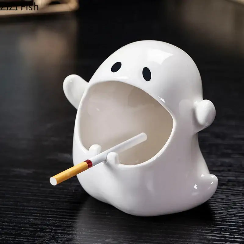 White ceramic ghost genie halloween porcelain ashtray with black eyes and wide mouth holding a cigarette for office decor