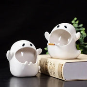 White ghost genie halloween porcelain ashtray with black eyes holding a cigarette for desk decor or office use