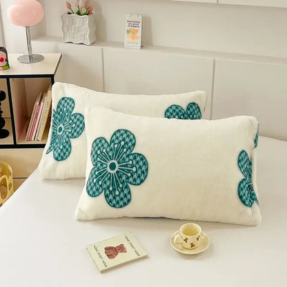 Cream-colored winter plush pillowcase with embroidered teal floral patterns and houndstooth texture for decorbites cozy winter decor
