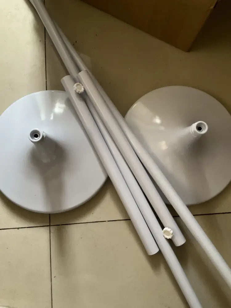 White glossy plastic butterfly chandelier stand with circular bases and cylindrical legs for dining room use