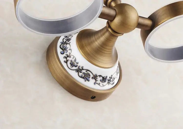 Antique brass and white ceramic double towel rack with blue floral detailing featured in decorbites brass toothbrush holder set