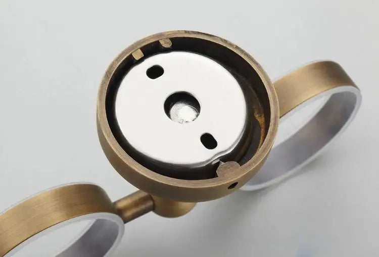 Brass-framed magnifying glass with silver-toned lens and two handles in decorbites brass toothbrush holder bathroom accessory