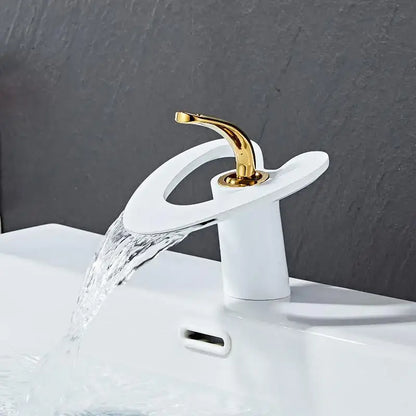A modern white ceramic basin faucet with a sleek curved spout and gold-toned handle for decorbites golden white style