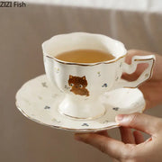 White gold trim ceramic teacup and saucer featuring a cute brown cartoon kitten pattern for dining room use