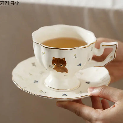 White gold trim ceramic teacup and saucer featuring a cute brown cartoon kitten pattern for dining room use