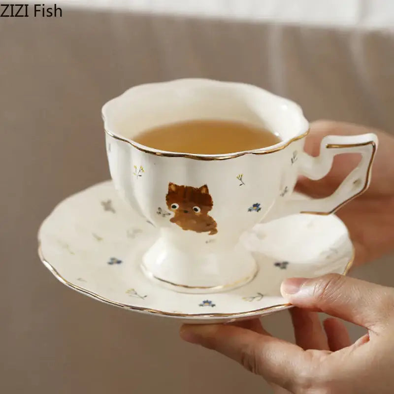 White gold trim ceramic teacup and saucer featuring a cute brown cartoon kitten pattern for dining room use