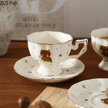 White gold trim ceramic mug and saucer with cartoon kitten pattern and cute brown kitten illustration for dining room