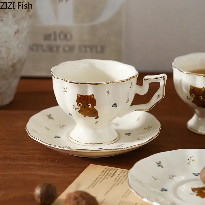 White gold trim ceramic mug and saucer with cartoon kitten pattern and cute brown kitten illustration for dining room