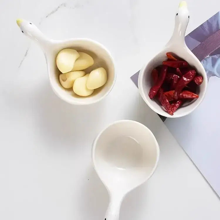White goose ceramic snack bowls with black and yellow beaks holding garlic and red dried chilies ideal as ceramic snack bowls