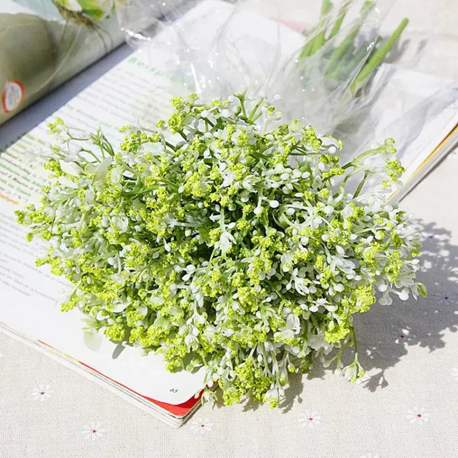 A delicate bouquet of white gypsophila artificial flowers with realistic green and white petals for wedding decor