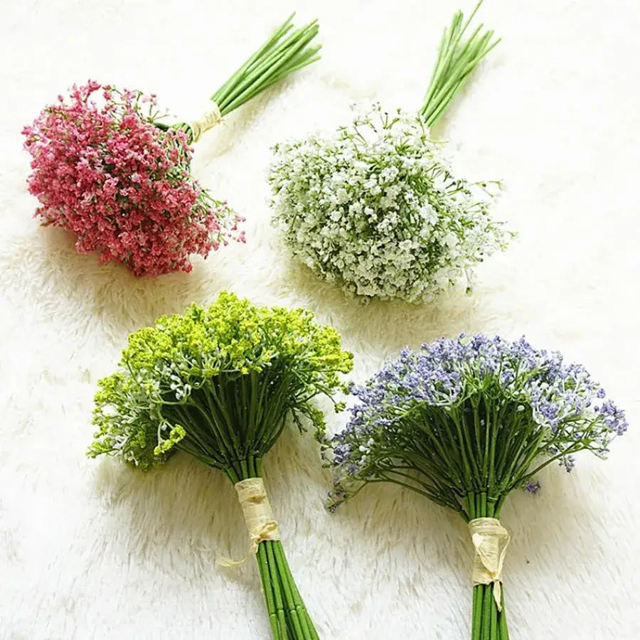 Four artificial flower bouquets in pink white lime green and purple hues tied with ribbons featuring gypsophila artificial flowers