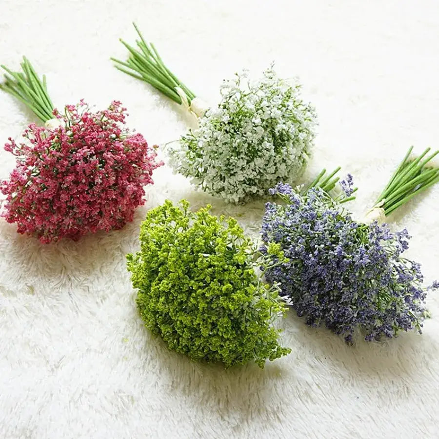 Four small artificial gypsophila bouquets in pink white green and purple with bundled stems for wedding decor