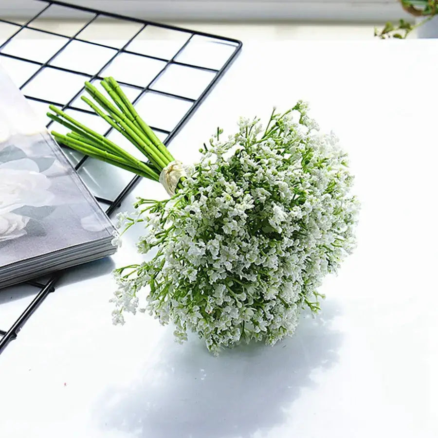 A delicate white gypsophila artificial flowers bouquet with tiny blossoms and green stems for wedding and home decor