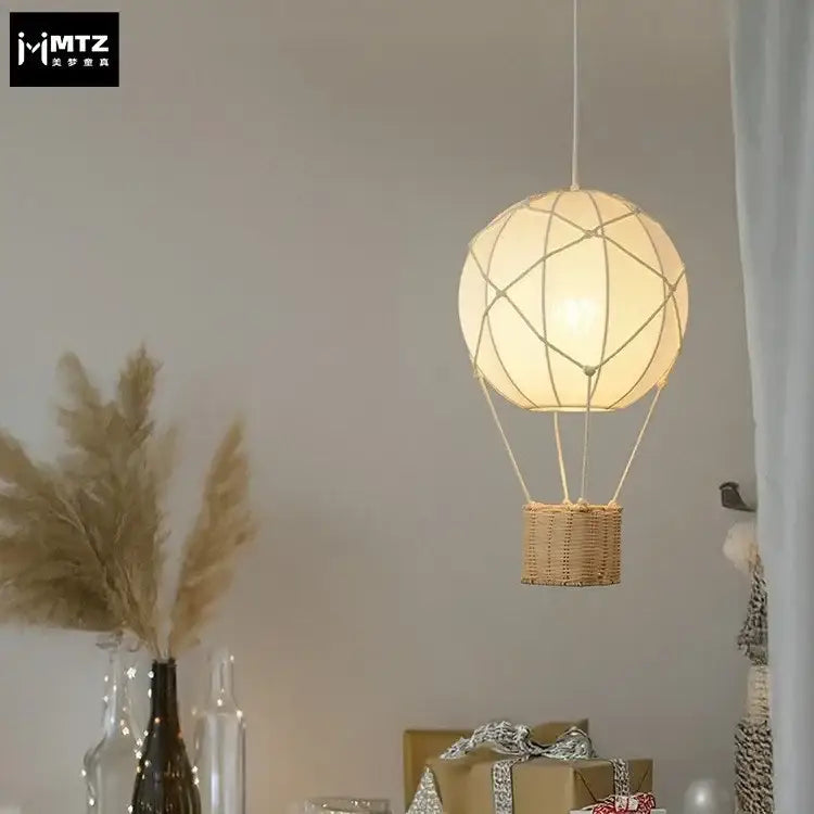 White hot air balloon chandelier with wicker basket and delicate string detailing for kids room decorbites hot air
