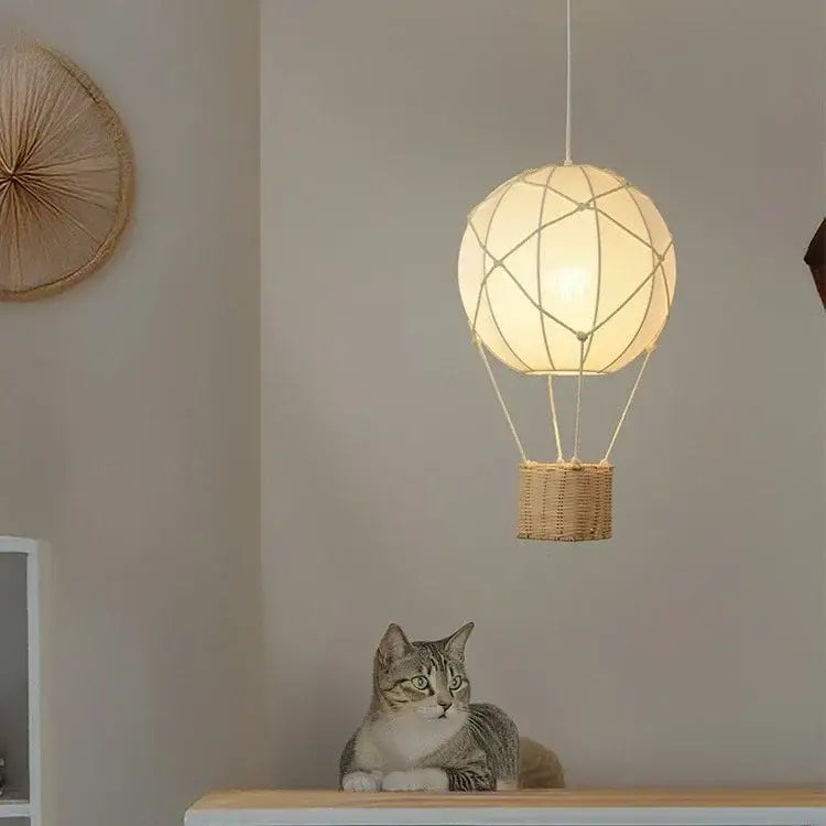 White hot air balloon chandelier with woven wicker basket and macrame string detailing for kids room decorbites hot air