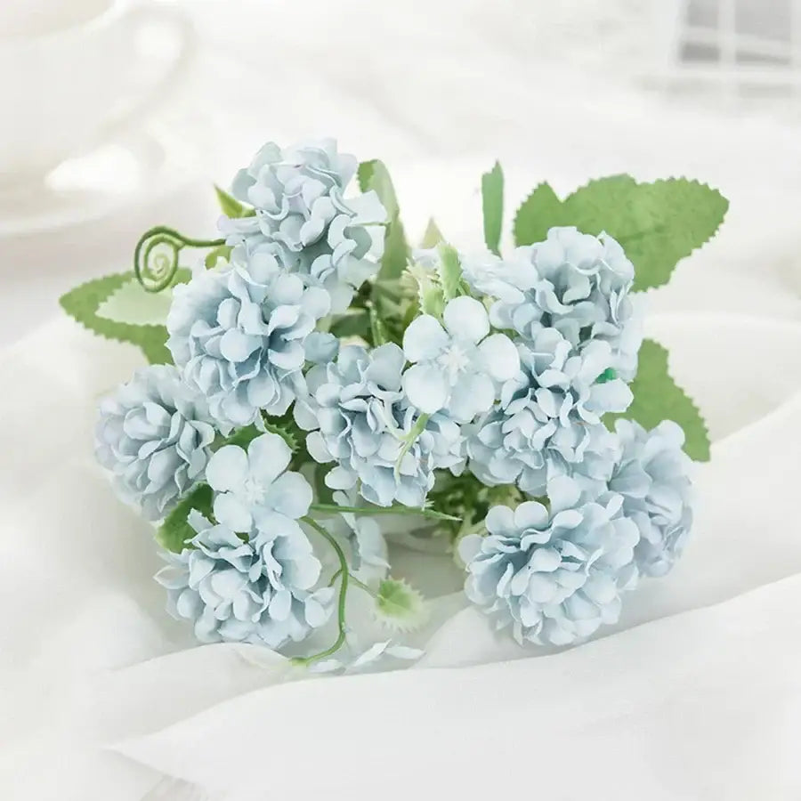 White hydrangea bouquet in ribbed glass vase featuring delicate light blue artificial flowers for living room decorbites decor