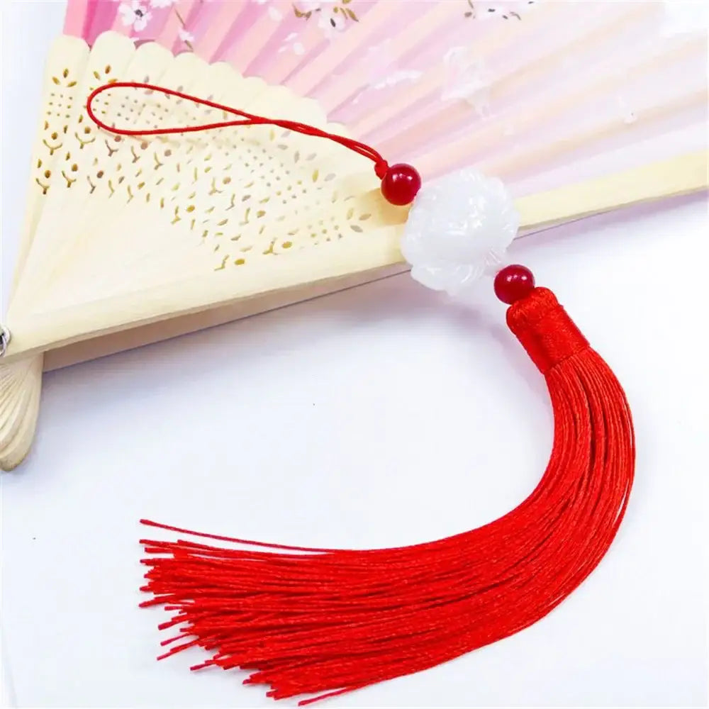 Delicate white jade lotus flower pendant with a pink tassel and beads for elegant living room decor