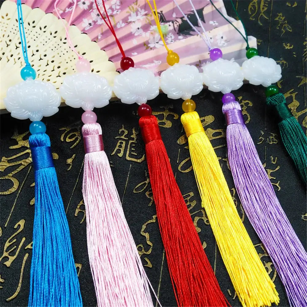 A set of white jade lotus tassel decorative pendants with carved jade lotus tops and colorful silk tassels for living room decor