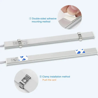 White led motion sensor cabinet light with silver metallic strip featuring adhesive backing and clamp mounting options