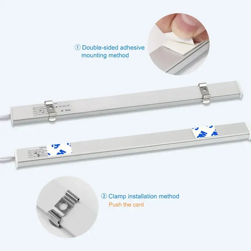 White led motion sensor cabinet light with silver metallic strip featuring adhesive backing and clamp mounting options
