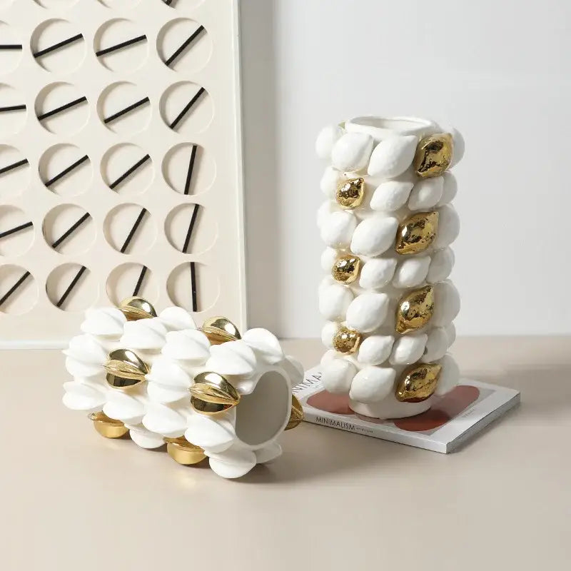 White ceramic vase with gold-accented shell-like protrusions featuring lemon carambola design for living room decor