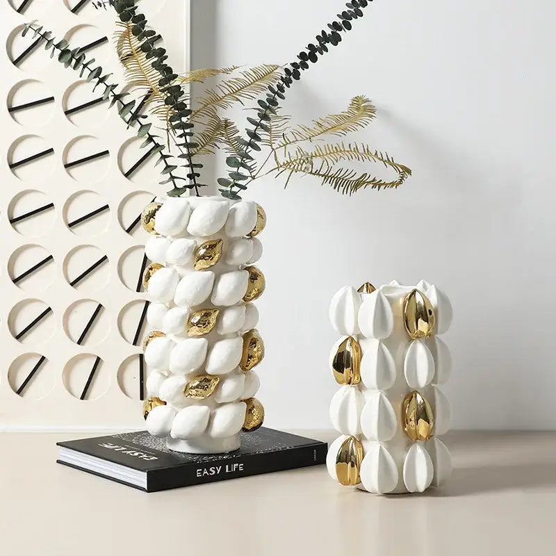 White ceramic vase with gold metallic accents and textured lemon carambola design for living room decor
