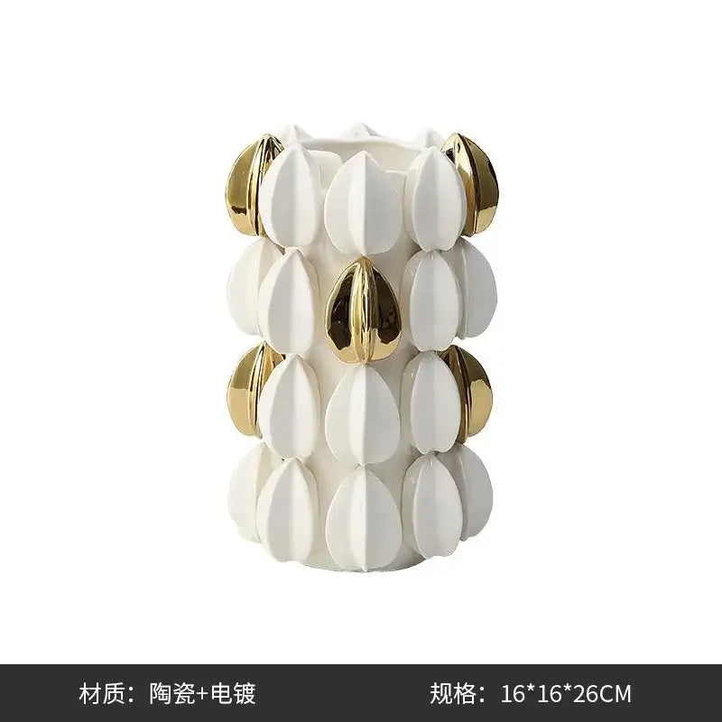 White ceramic vase with gold-toned petal accents in a lemon carambola design for living room decor