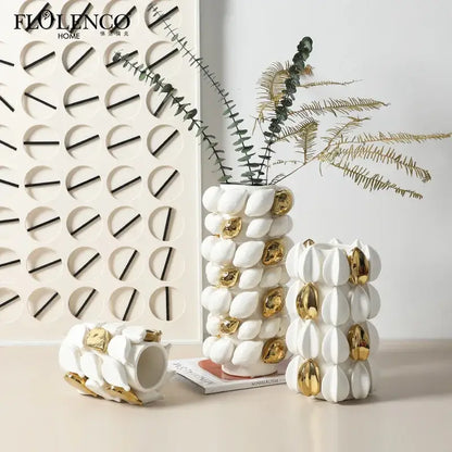 White ceramic vase with gold leaf accents and textured segmented lemon carambola design for living room decor