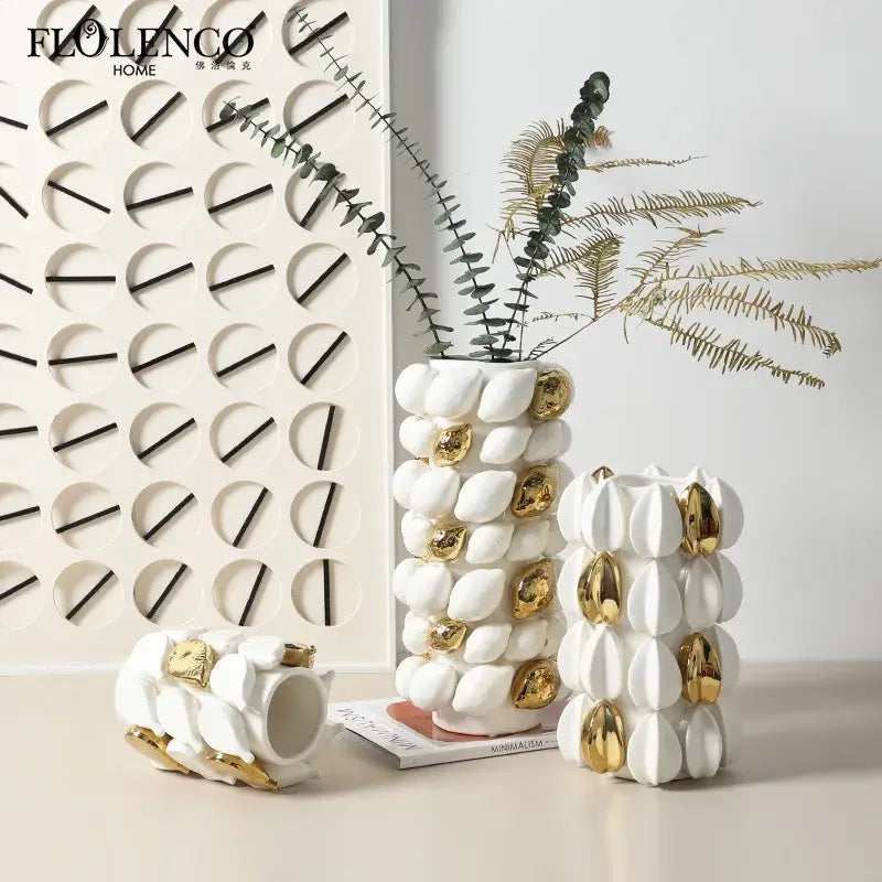 White ceramic vase with gold leaf accents and textured segmented lemon carambola design for living room decor