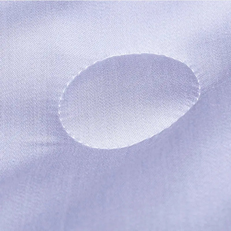A soft lavender satin fabric with an oval cutout for the white and light blue decorbites cool feel summer quilt blanket