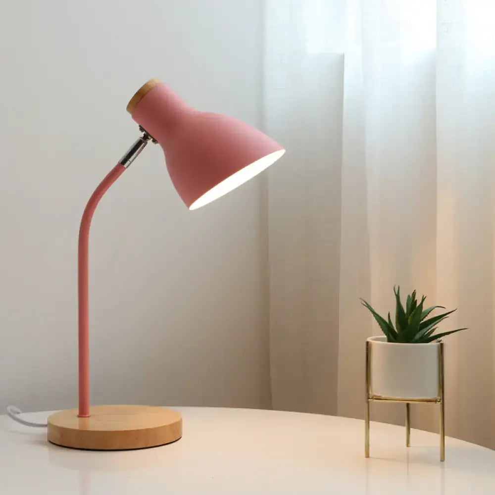 Pink macaron metal table light with adjustable gooseneck, curved metal arm, and wooden base for bedroom use