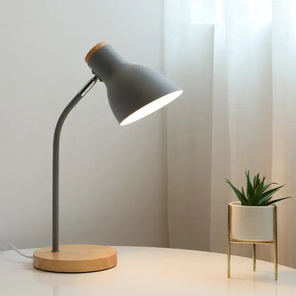 Gray macaron metal table light with wooden base and adjustable gooseneck design for bedroom use