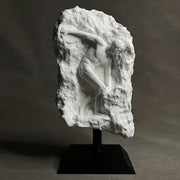 White marble discus throwing nude sculpture in dynamic pose carved into rugged rock for home decor in living room