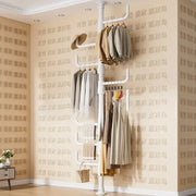 White multi tiered ladder clothing storage rack with multiple hanging bars and ladder-style shelf for coat rack use