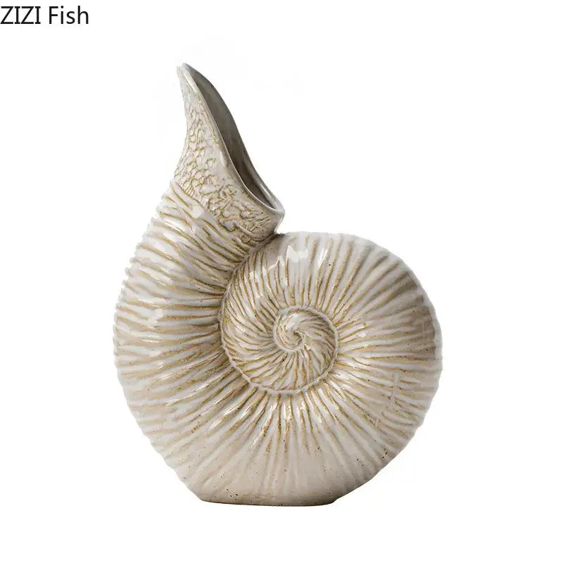 Cream-colored decorbites conch ceramic vase shaped like a nautilus shell with intricate ridged detailing for decor