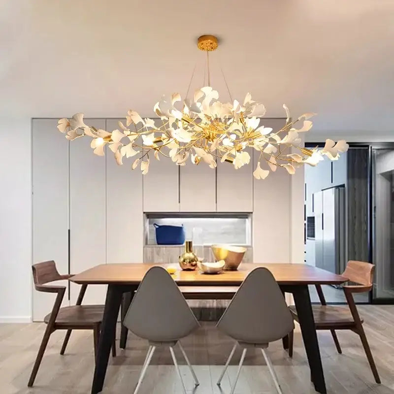 A modern decorbites ginkgo chandelier with golden branches and white petal-like lights for living room pendant lighting